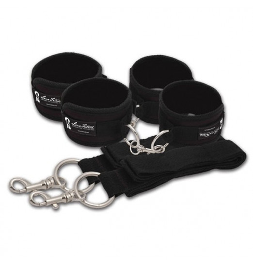 Две пары черных наручников, крепящиеся к матрасу