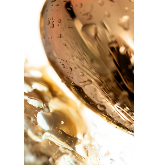 Золотистая гладкая коническая анальная пробка с красным кристаллом - 7 см.