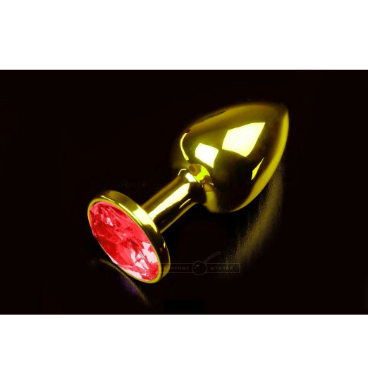 Маленькая золотистая анальная пробка с круглым кончиком и красным кристаллом - 7 см.