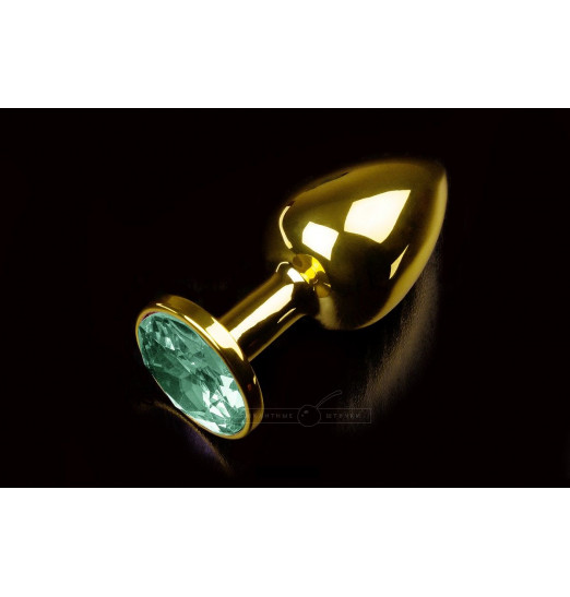 Маленькая золотистая анальная пробка с круглым кончиком и изумрудным кристаллом - 7 см.